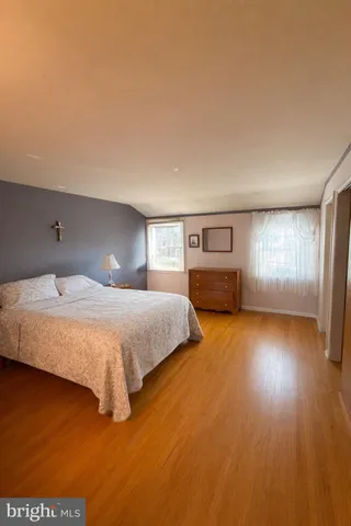 a spacious bedroom with a bed and window