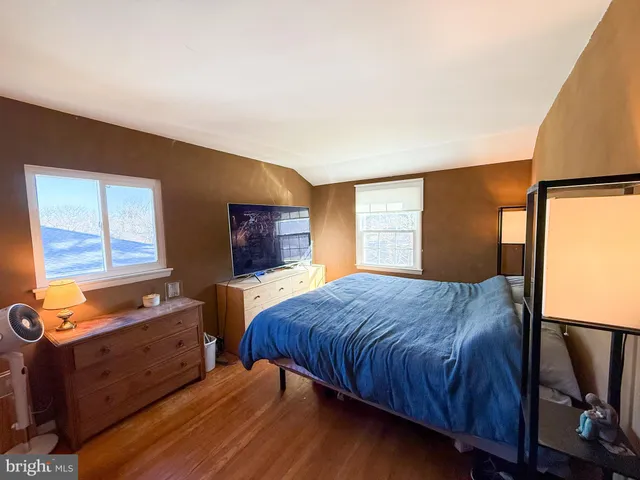 a bed room with a bed and a tv on dresser