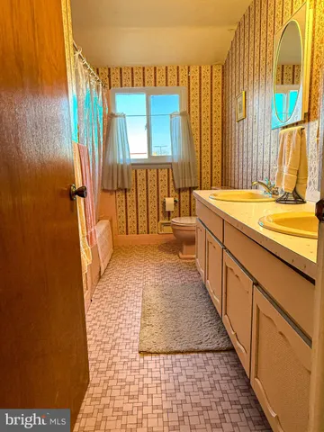 a bathroom with a sink a mirror and a shower