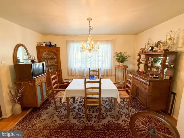 a living room with furniture a window and a chandelier
