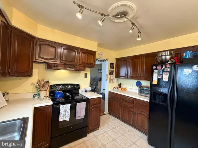 a kitchen with stainless steel appliances granite countertop a refrigerator stove and sink