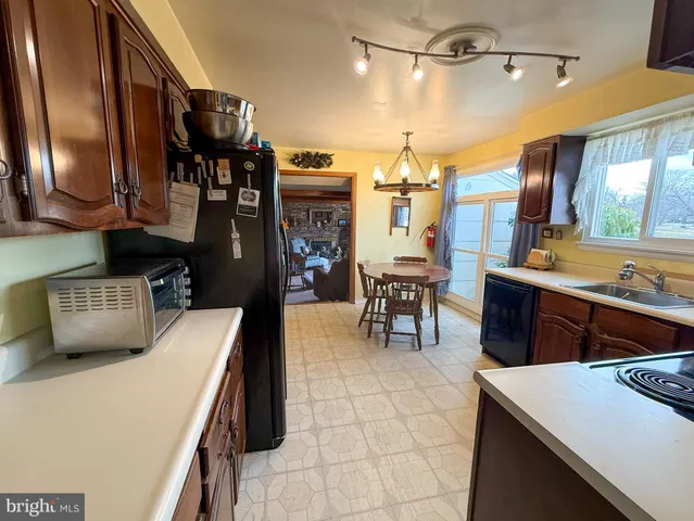 a kitchen with stainless steel appliances a sink a stove and a refrigerator