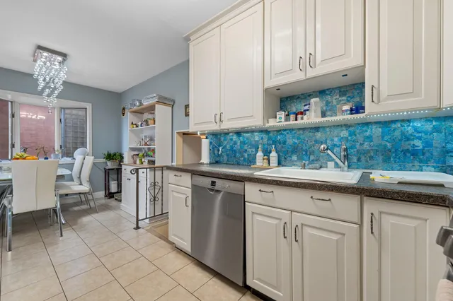 a kitchen with stainless steel appliances granite countertop a sink and cabinets
