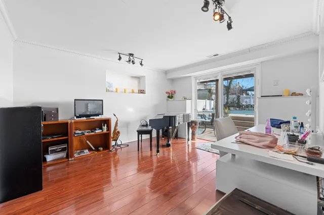 a living room with furniture and wooden floor