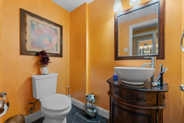 a bathroom with a toilet a sink and mirror