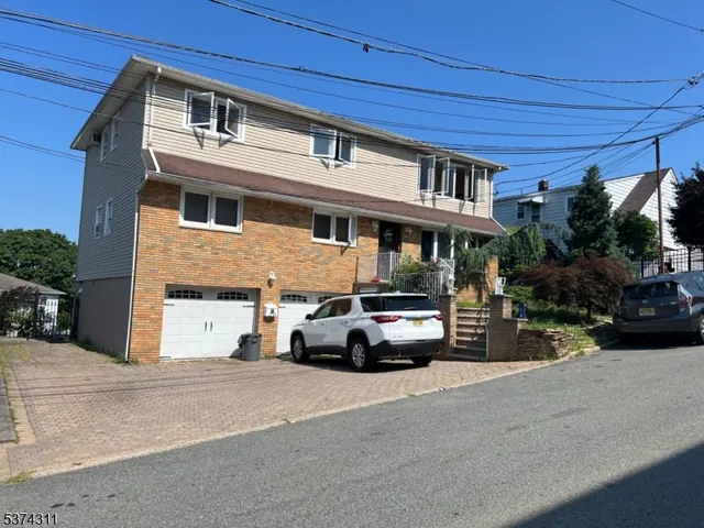 a view of a street that has couple of cars parked on the road