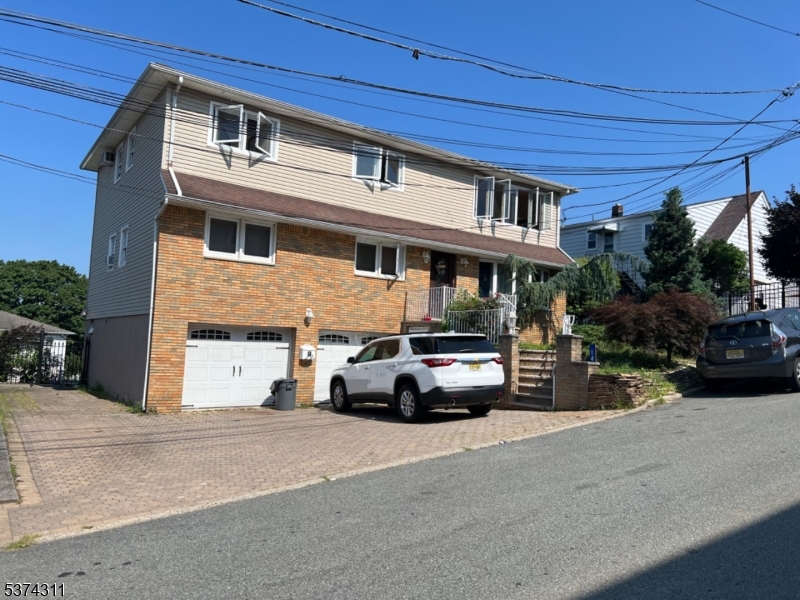 a view of a street that has couple of cars parked on the road