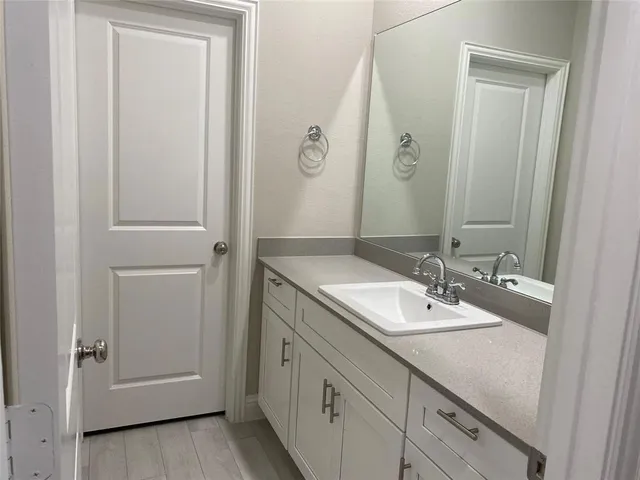 a bathroom with a double vanity sink and mirror