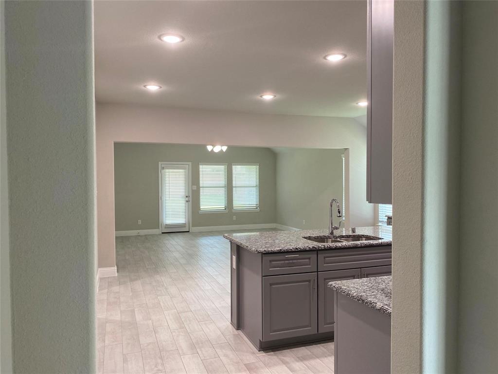 4162 Perch Drive Forney, TX 75126 - Photo 5 of 22 a bathroom with a granite countertop sink and a mirror