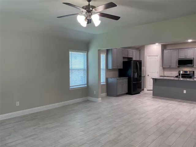 a view of a kitchen with a sink stainless steel appliances and cabinets
