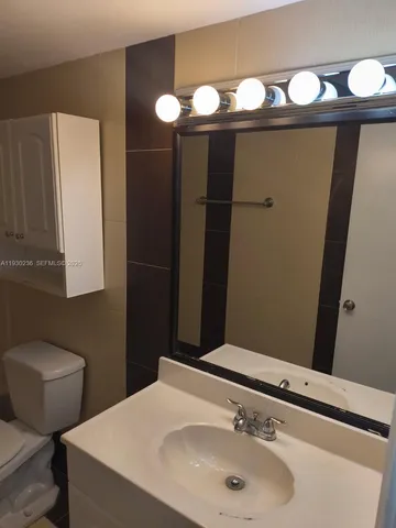 a bathroom with a sink and mirror