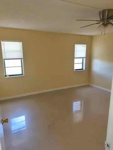 a view of an empty room and a window