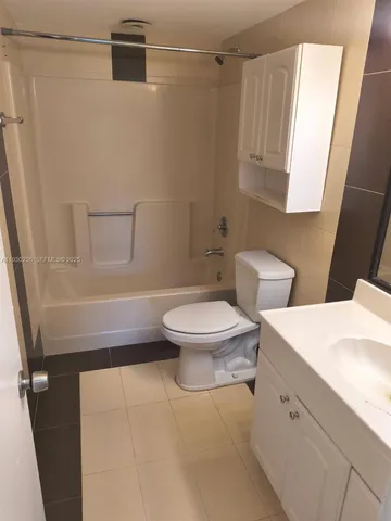 a bathroom with a toilet a sink and a mirror