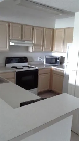 a kitchen with stainless steel appliances a sink stove and cabinets