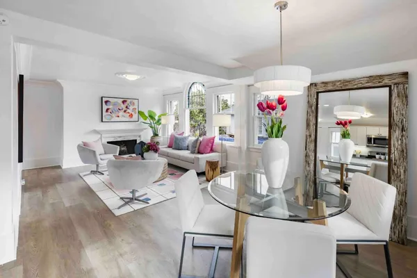 a living room with furniture and a chandelier