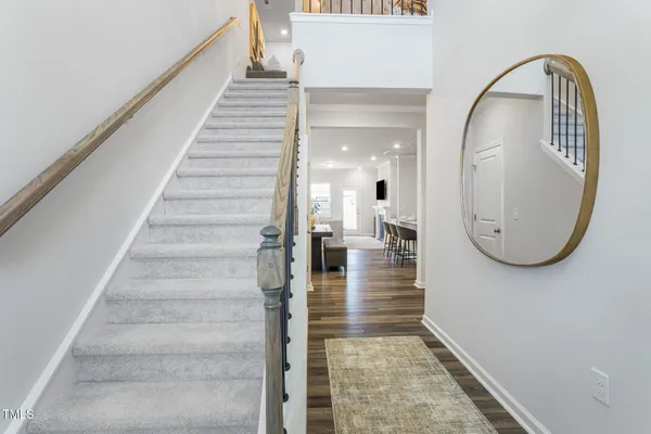 a view of a hallway with wooden floor and entryway