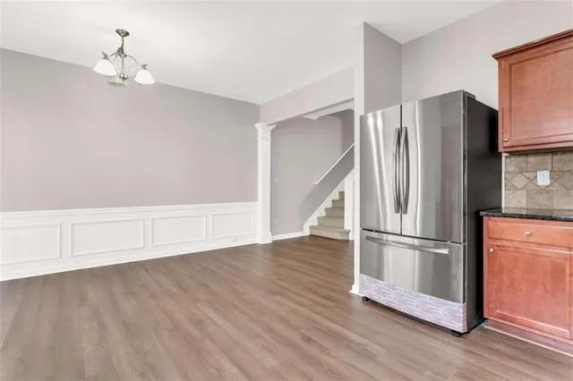 a view of a kitchen with wooden floor and electronic appliances
