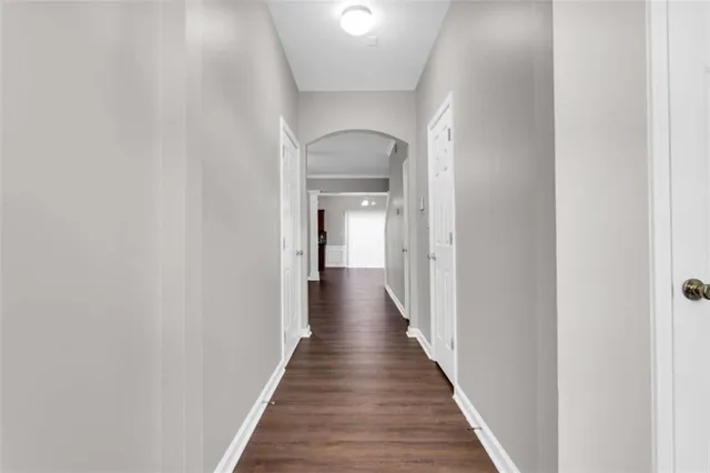 a view of a hallway with a wooden floor