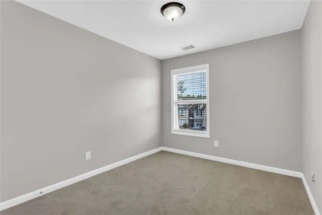 an empty room with a empty space and windows