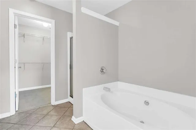 a bathroom with a tub and shower