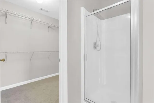 a bathroom with a glass shower door