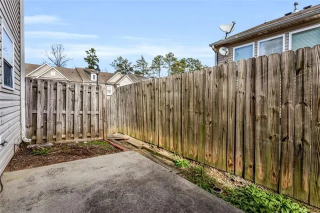 a view of a pathway with a wooden fence