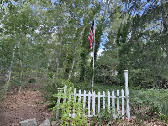 a wooden fence with trees in the background