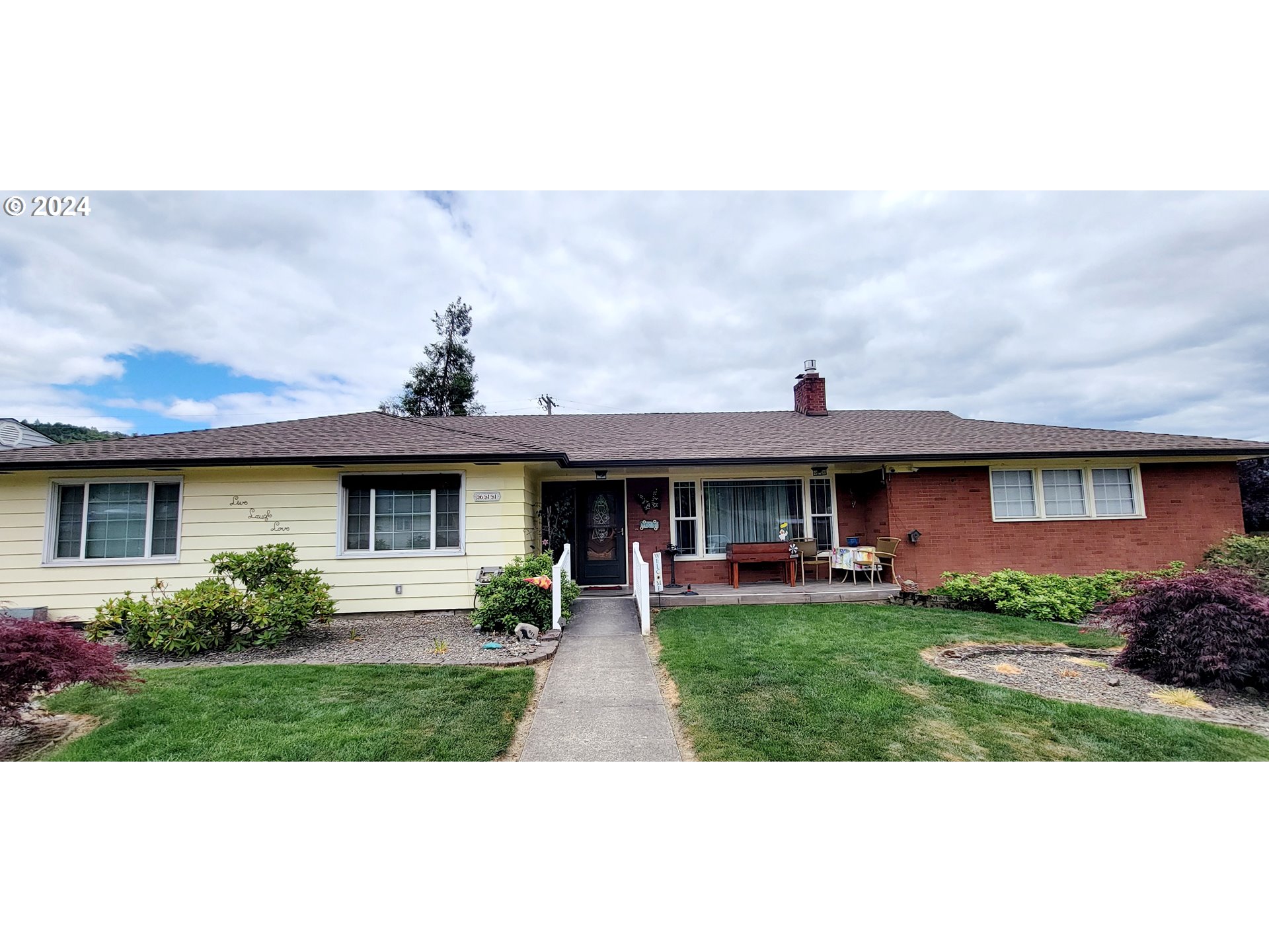 611 East 3rd Avenue Riddle, OR 97469 - Photo 1 of 42 a front view of a house with a garden
