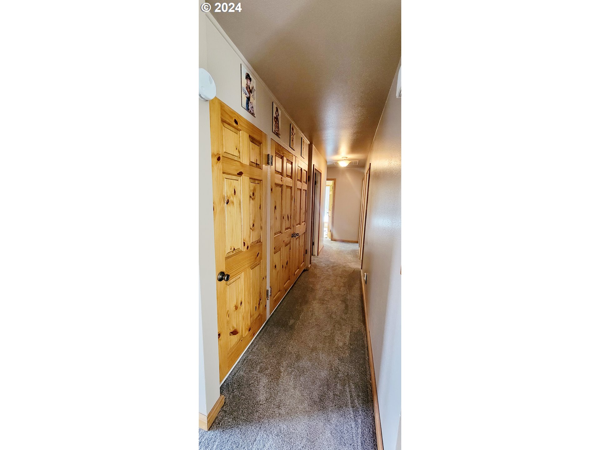 611 East 3rd Avenue Riddle, OR 97469 - Photo 17 of 42 a view of a hallway with wooden floor