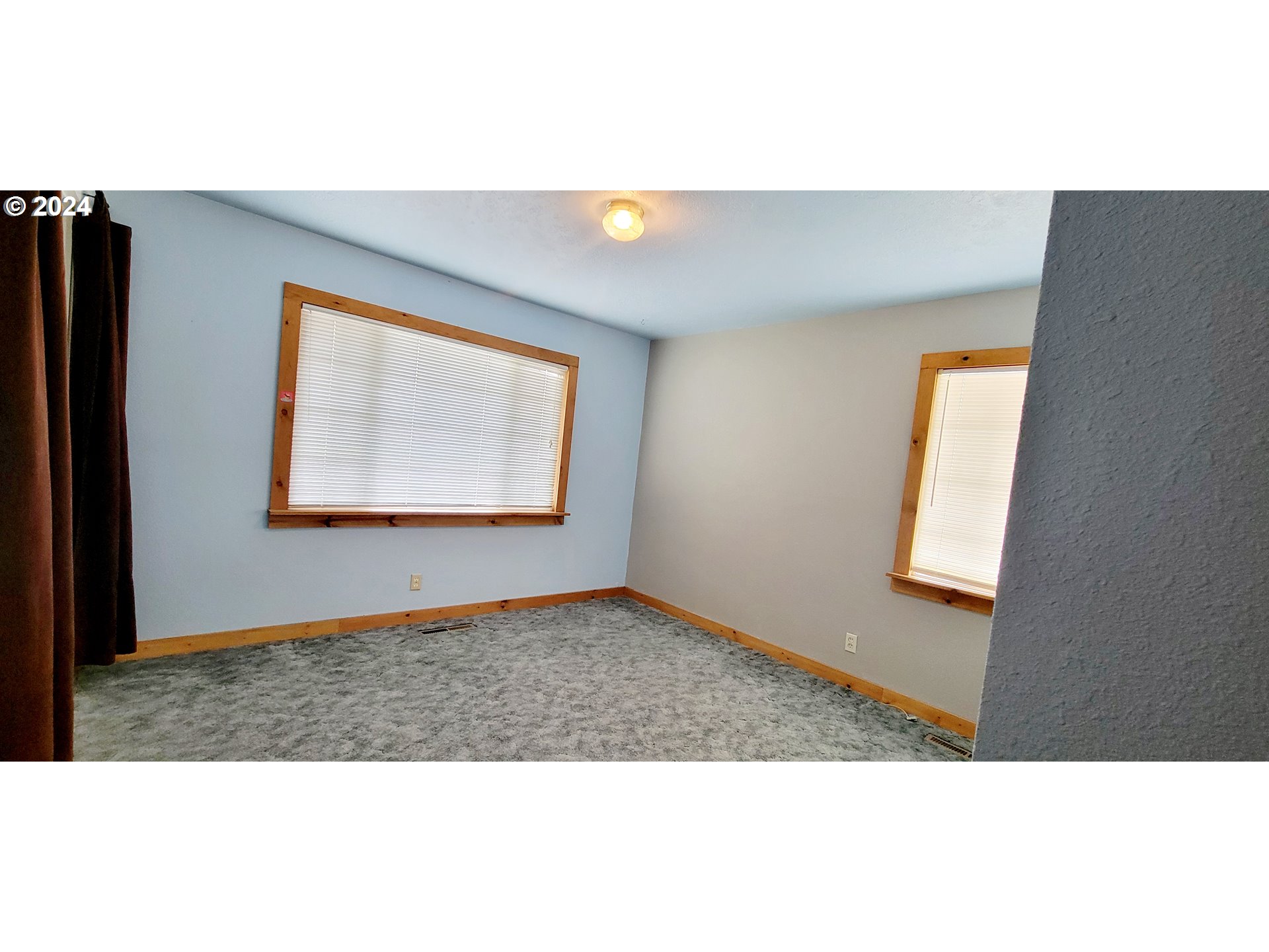 611 East 3rd Avenue Riddle, OR 97469 - Photo 27 of 42 a view of an empty room with wooden floor and a window