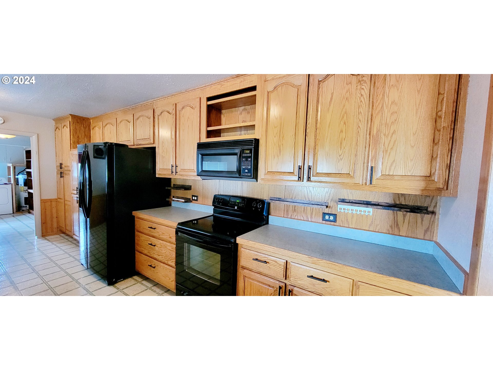 611 East 3rd Avenue Riddle, OR 97469 - Photo 8 of 42 a kitchen with a refrigerator and a sink