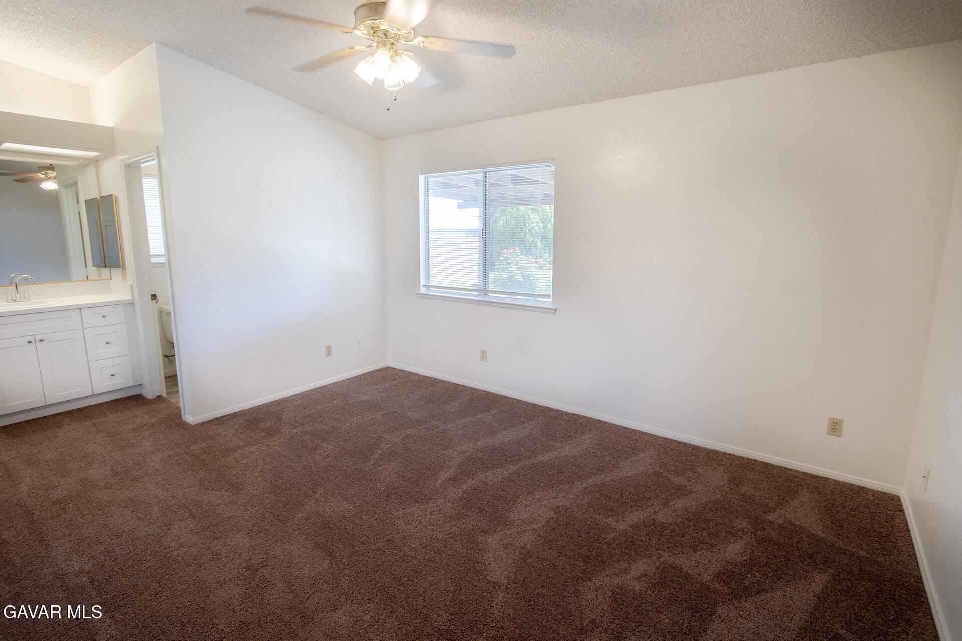 44318 33rd Street West Lancaster, CA 93536 - Photo 20 of 29 an empty room with chandelier fan and windows