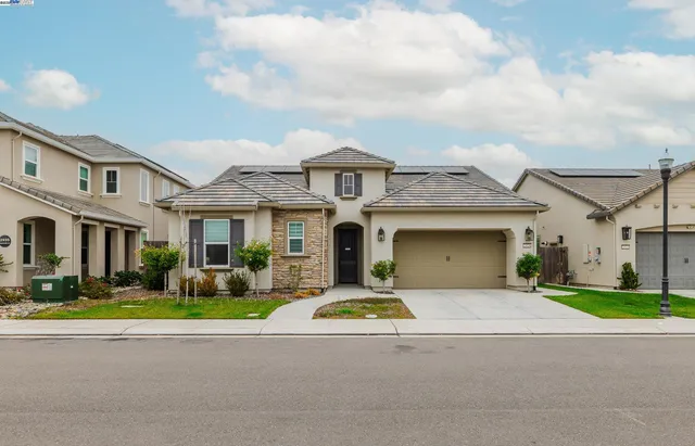 a front view of a house with a garden and pathway