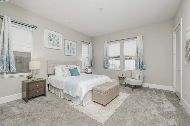 a spacious bedroom with a bed and a window