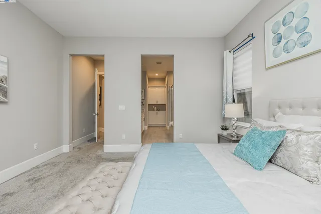 a bedroom with a large bed and a couch