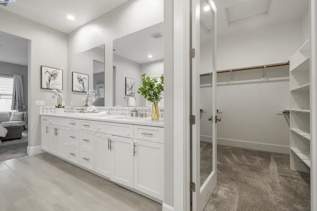 a bathroom with a shower sink and mirror
