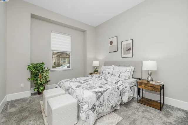 a bedroom with a bed and a potted plant