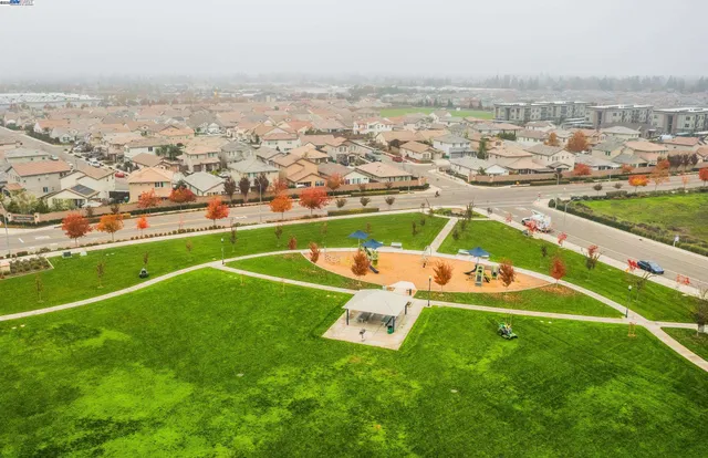 an aerial view of a houses with a yard