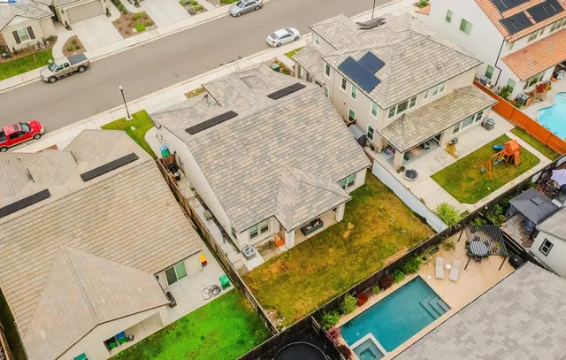 an aerial view of a house with a swimming pool