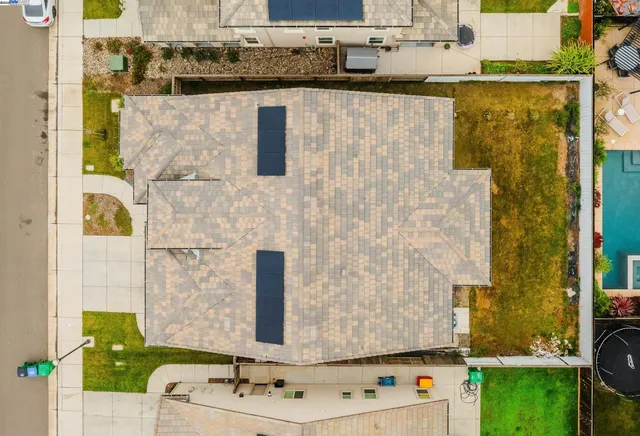 an aerial view of a house with a yard and a garden