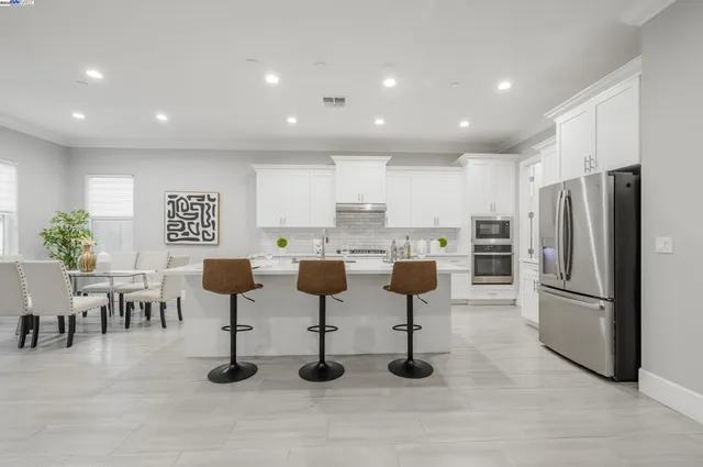 a kitchen with lots of white furniture