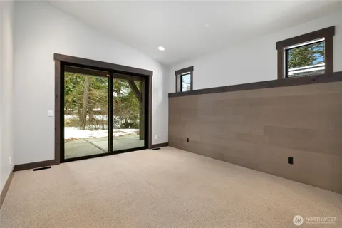 an empty room with large windows