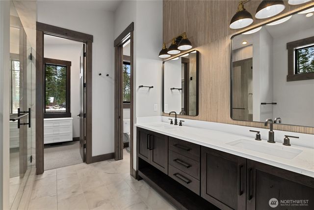 a spacious bathroom with a double vanity sink double mirror and bathtub