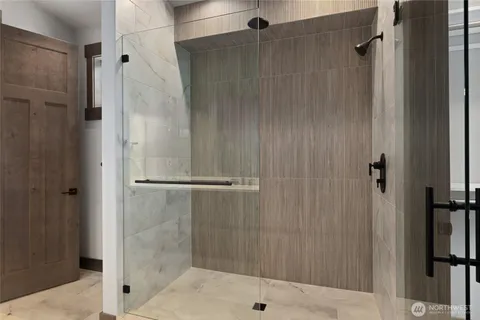 a bathroom with a glass shower door