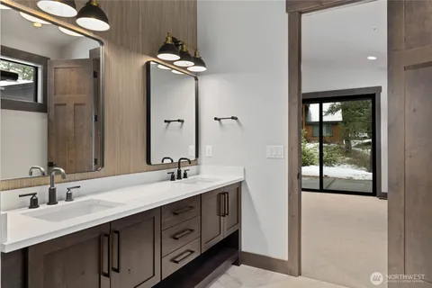 a bathroom with a double vanity sink and mirror