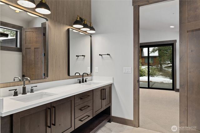 a bathroom with a double vanity sink and mirror