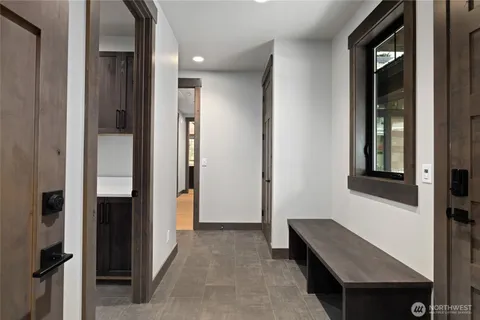 hallway with wooden floor and glass door
