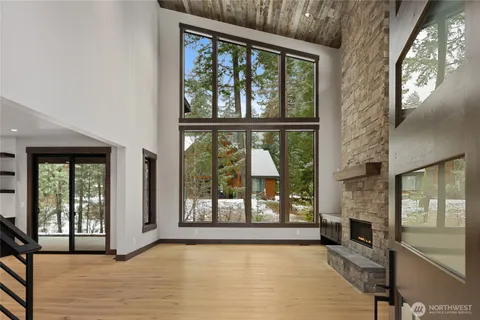 a view of an empty room with a fireplace and a window