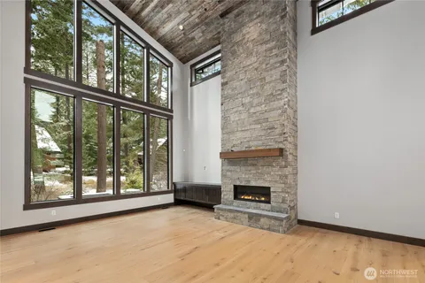 a view of an empty room with a fireplace and a window