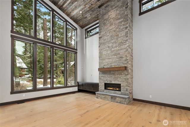 a view of an empty room with a fireplace and a window